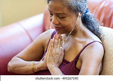 Senior Woman Meditating At Home