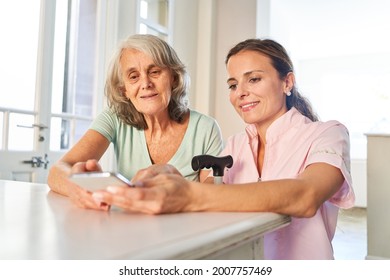 Senior Woman As Mother And Daughter During Video Chat With The Smartphone At Home Or In The Nursing Home