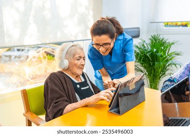 Senior woman and nurse using digital tablet and headphone in the geriatrics - Powered by Shutterstock