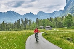 Senior Woman On Electric Mountain Bike On The Bregenz Forest Bicycle Track Up To Hochtannberg Pass, Vorarlberg, Austria