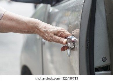 Senior Woman Open Car Door 