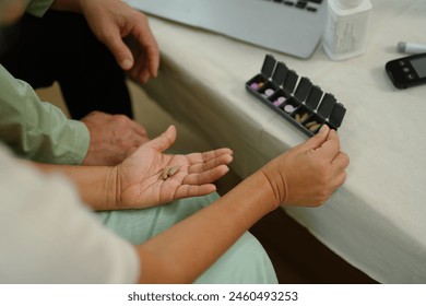 Senior woman organizing her medication into pill dispenser. Health care and medication concept - Powered by Shutterstock