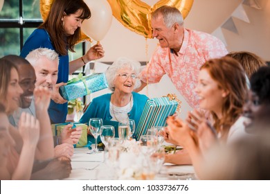 Senior Woman Is Overwhelmed With Emotion As She Is Surprised With A Birthday Party By Her Friends And Family. 