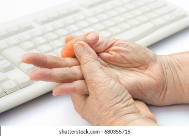 Senior woman painful finger due to prolonged use of keyboard and