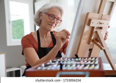 Senior Woman Painting On Canvas