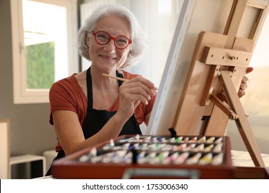 Senior Woman Painting On Canvas