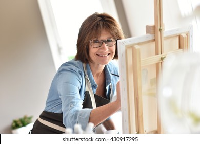 Senior Woman Painting On Canvas