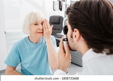 Senior woman patient checking vision in optician's office. Eye exam and vision diagnostic - Powered by Shutterstock