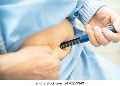 Senior woman patient injecting insulin for treat diabetes. - Powered by Shutterstock