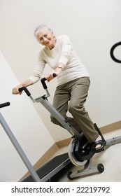 Senior Woman Pedaling On Stationery Bike