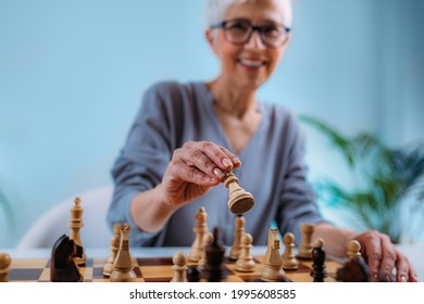 Senior Woman Playing Chess. Cognitive Rehabilitation Therapy.