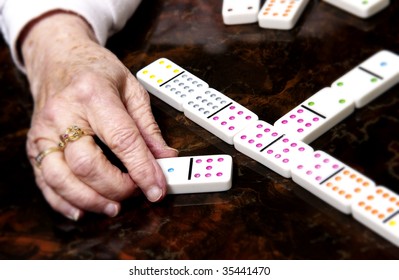 Senior Woman Playing Dominoes