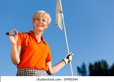 Senior Woman Playing Golf Holding The Flag In Her Hand