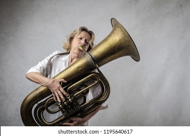 Senior woman playing on a tuba