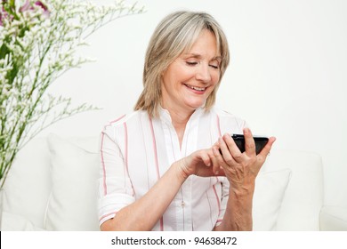 Senior Woman Playing An Online Game On Smartphone