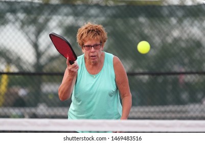 A Senior Woman Plays Pickle Ball