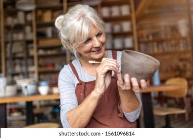 Senior woman pottery artist makes ceramics from clay
 - Powered by Shutterstock