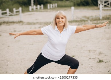 Senior woman practicing yoga outdoors, staying active and healthy in nature. Embracing fitness with positivity and energy. - Powered by Shutterstock