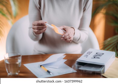 Senior Woman Preparing DNA Genetic Test Kit