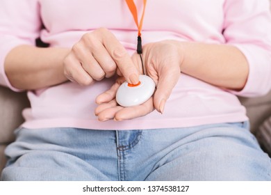 Senior Woman Pressing Alarm Button, Using Emergency Call System, Closeup