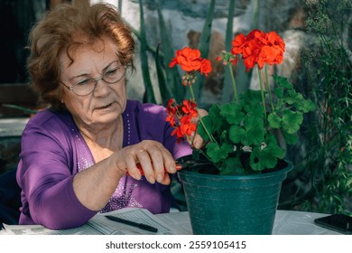 senior woman pruning and caring for plants in the garden or orchard - Powered by Shutterstock