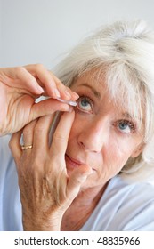 Senior Woman Putting Eye Drops