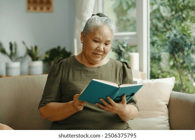 Senior Woman Reading Book At Home - Powered by Shutterstock