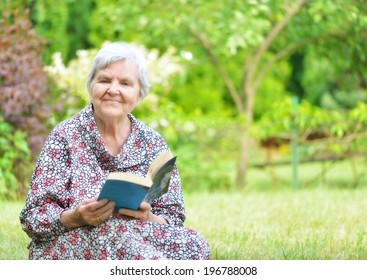 Senior Woman Reading Book In Park. MANY OTHER PHOTOS FROM THIS SERIES IN MY PORTFOLIO.