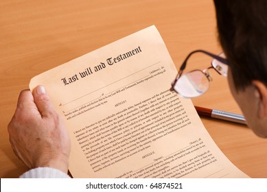 Senior Woman Reading Last Will And Testament Sitting On Desk