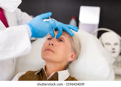 Senior Woman Receiving Beauty Injections For Face Skin Rejuvenating And Tightening For Female Client In Aesthetic Medicine Office