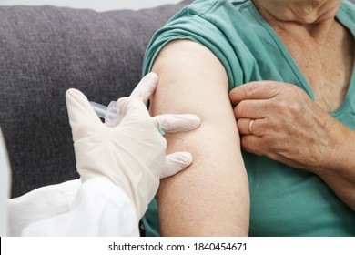Senior Woman Receiving Vaccine. Medical Worker Vaccinating An Elderly Patient Against Flu, Influenza, Pneumonia Or Coronavirus.