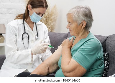 Senior Woman Receiving Vaccine. Medical Worker Vaccinating An Elderly Patient Against Flu, Influenza, Pneumonia Or Coronavirus.