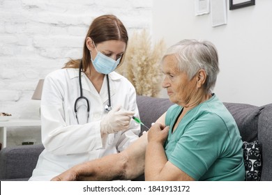 Senior woman receiving vaccine. Medical worker vaccinating an elderly patient against flu, influenza, pneumonia or coronavirus.