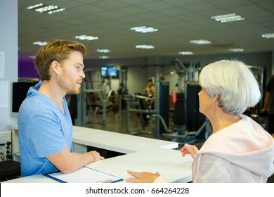 Senior Woman Registering At Health Club