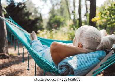 Senior woman relaxing in hammock in the garden on a sunny day
 - Powered by Shutterstock