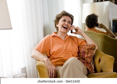 Senior Woman Relaxing At Home Chatting On Mobile Phone