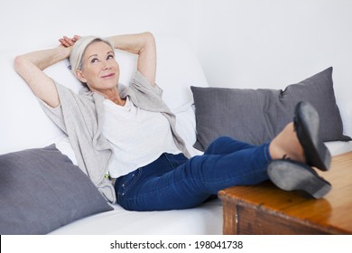 Senior Woman Relaxing On Her Sofa.