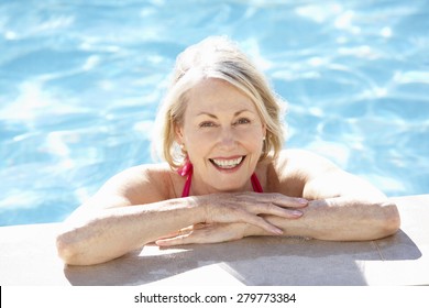Senior Woman Relaxing In Swimming Pool
