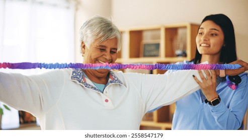 Senior woman, resistance band and exercise with physiotherapist for fitness, wellness and muscle. People, training and support, performance and recovery in physiotherapy, workout and health in clinic - Powered by Shutterstock