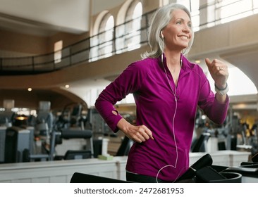 Senior woman, running on treadmill and smile for music in gym club, cardio and breathing for health in wellness. Mature, female runner and exercise with podcast, happy and workout by speed machine - Powered by Shutterstock