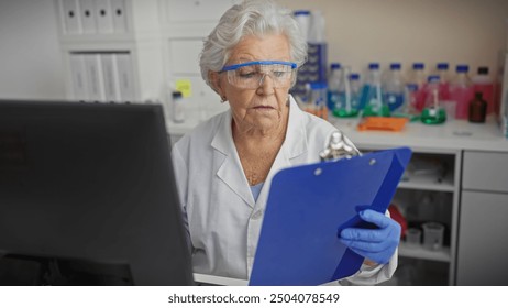 A senior woman scientist in a laboratory analyzes data on a clipboard, surrounded by chemical bottles and equipment. - Powered by Shutterstock