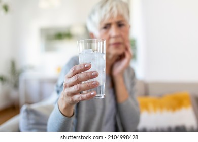 Senior Woman With Sensitive Teeth And Hand Holding Glass Of Cold Water With Ice. Healthcare Concept. Mature Woman Drinking Cold Drink, Glass Full Of Ice Cubes And Feels Toothache, Pain