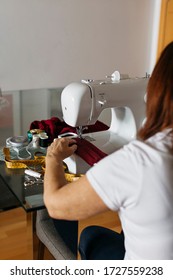 Senior Woman Sewing Cloth Face Masks For Family And Friends