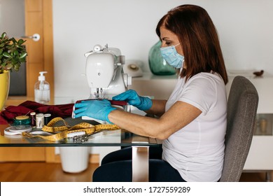 Senior Woman Sewing Cloth Face Masks For Friends And Family