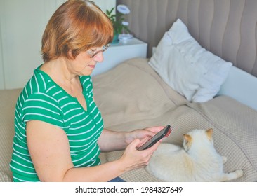 Senior woman shopping online in her bedroom at home. Lifestyle. Copy space - Shutterstock ID 1984327649