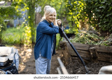 Senior woman shoveling compost heap in her garden
 - Powered by Shutterstock