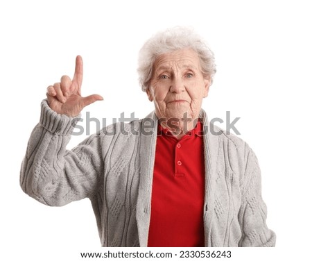 Senior woman showing loser gesture on white background