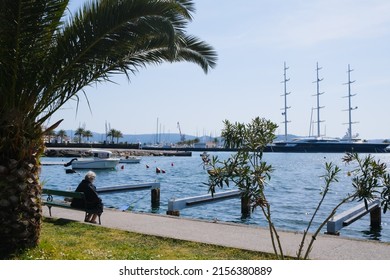 Senior Woman Silhouette Sitting On The Bench On Pier At The Sea. Retiree Lifestyle At Paradise Place Concept. Shallow Focus