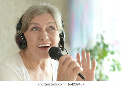 Senior Woman Singing Into Microphone