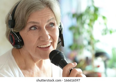 Senior Woman Singing Into Microphone